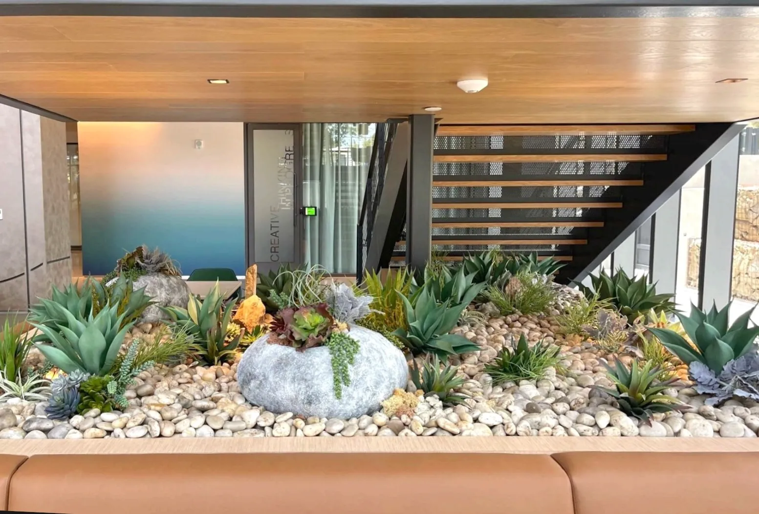 Faux succulent and agave bed under a staircase