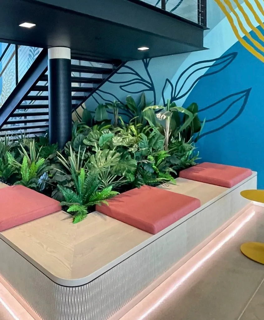 A faux planter behind a bench