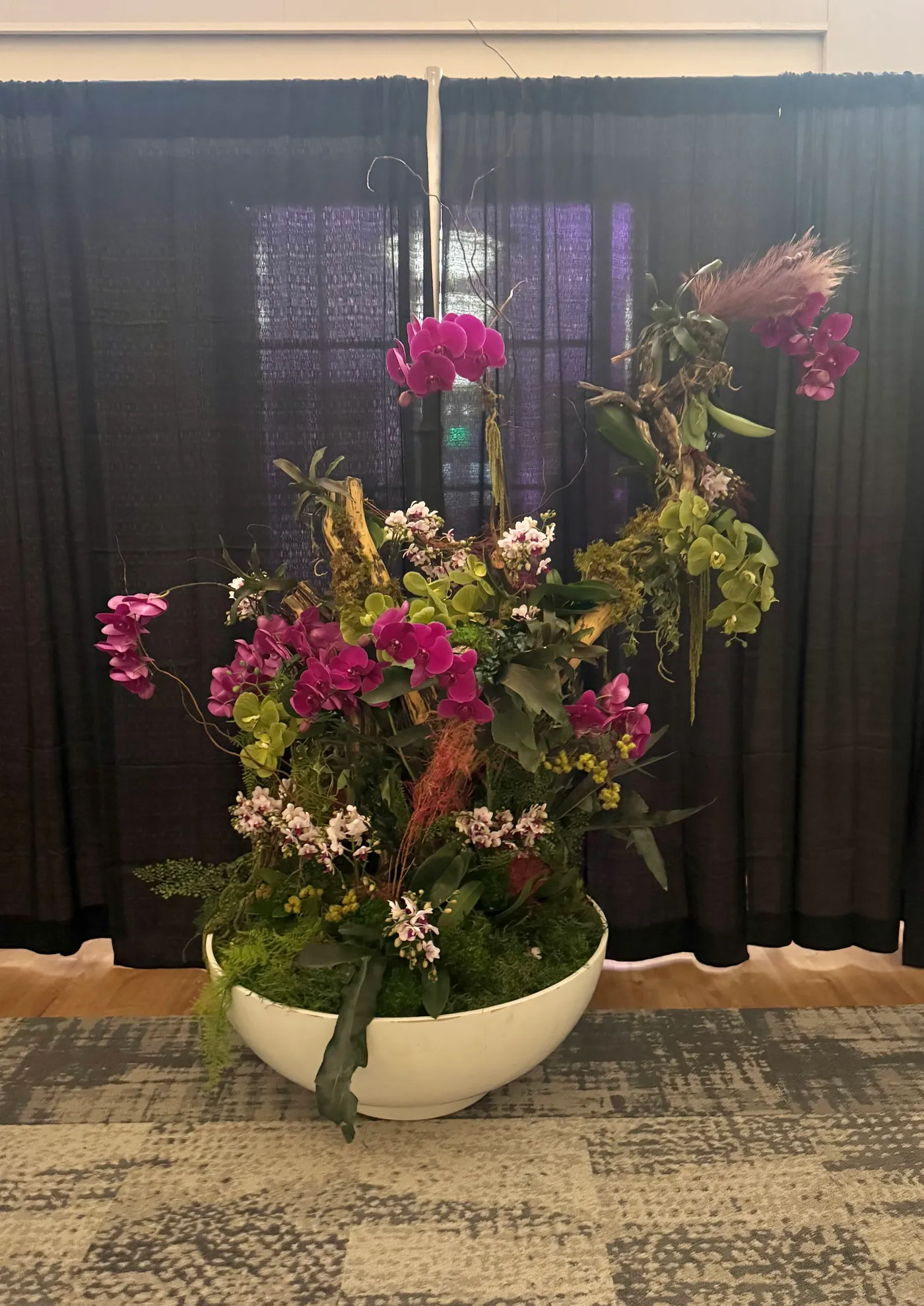 An orchid floral piece at an event